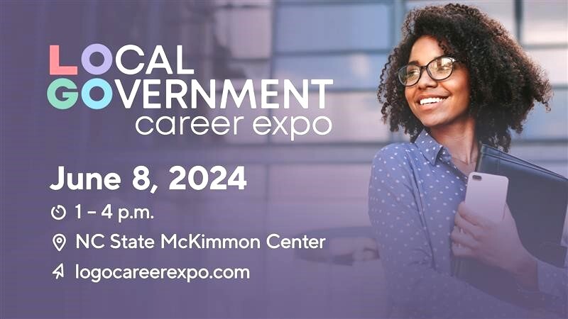 A woman holding a book advertising a career event.